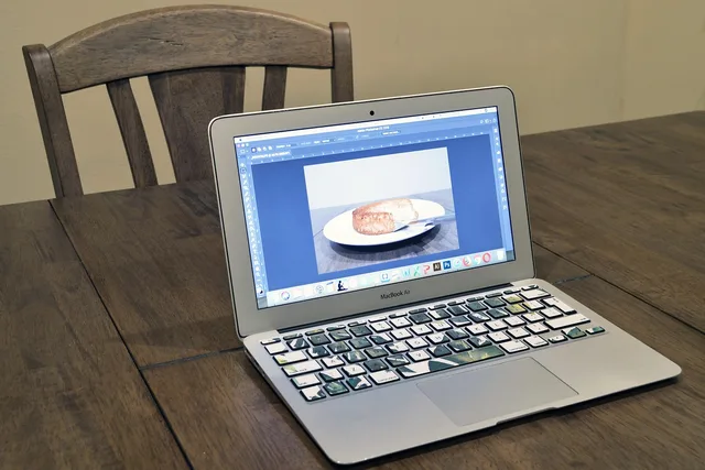 computer, laptop, technology, photoshop, adobe, design, designer, work, working, screen, wood, wooden, table, home, macbook air, macbook, brown computer, brown laptop. Four England ad workflows to test creative tools against in 2027