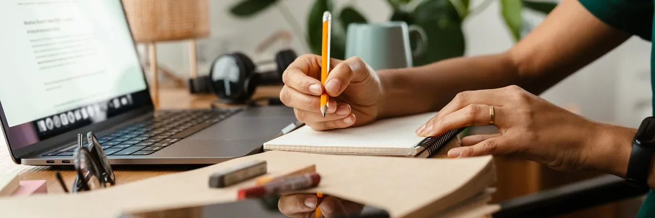 people, woman, adult, panoramic, young, girl, african, american, sketchbook, write, pencil, notebook, laptop, computer, desk, room, study, work, home, apartment, sit, day, one, panorama, indoors