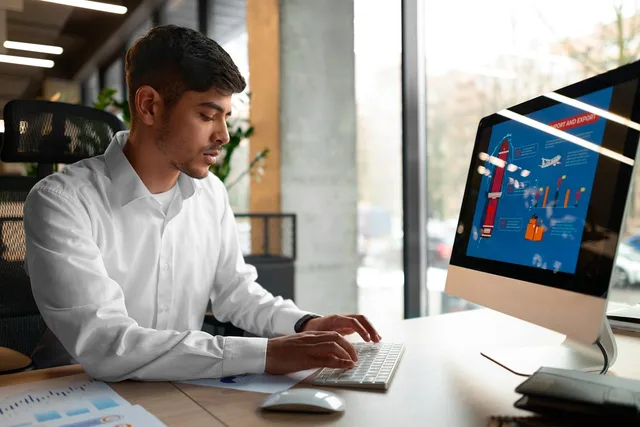office, worker, computer, graphics, keyboard, man, monitor, workspace, analysis, data sheet, concentration, work environment, diligence, employment, camera, internet, city background, daylight, casual, ai generated. Choose creative advertising software with a task specimen, not a sales demo