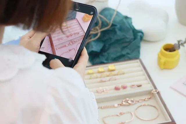 filming, cell phone, prop, jewelry, ring, necklace, studio, model, woman, craft, social media. Social media ad design tools for shoppable ads